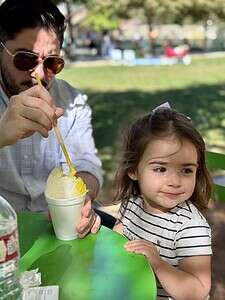 Family enjoying ice cream outdoors on a sunny day at The Migoni Kitchen.