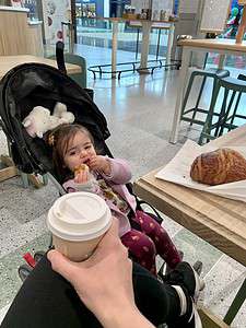 Child enjoying a snack and coffee at The Migoni Kitchen cafe.