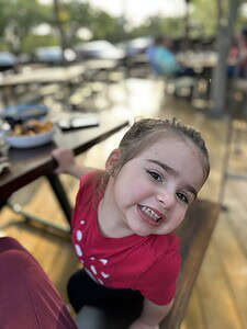 Child enjoying cookies outdoors at The Migoni Kitchen.