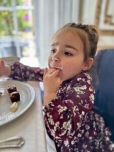 Child eating cake with frosting at The Migoni Kitchen.