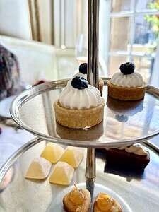 Delicious mini lemon tarts topped with blueberries, served on a tiered tray at The Migoni Kitchen.