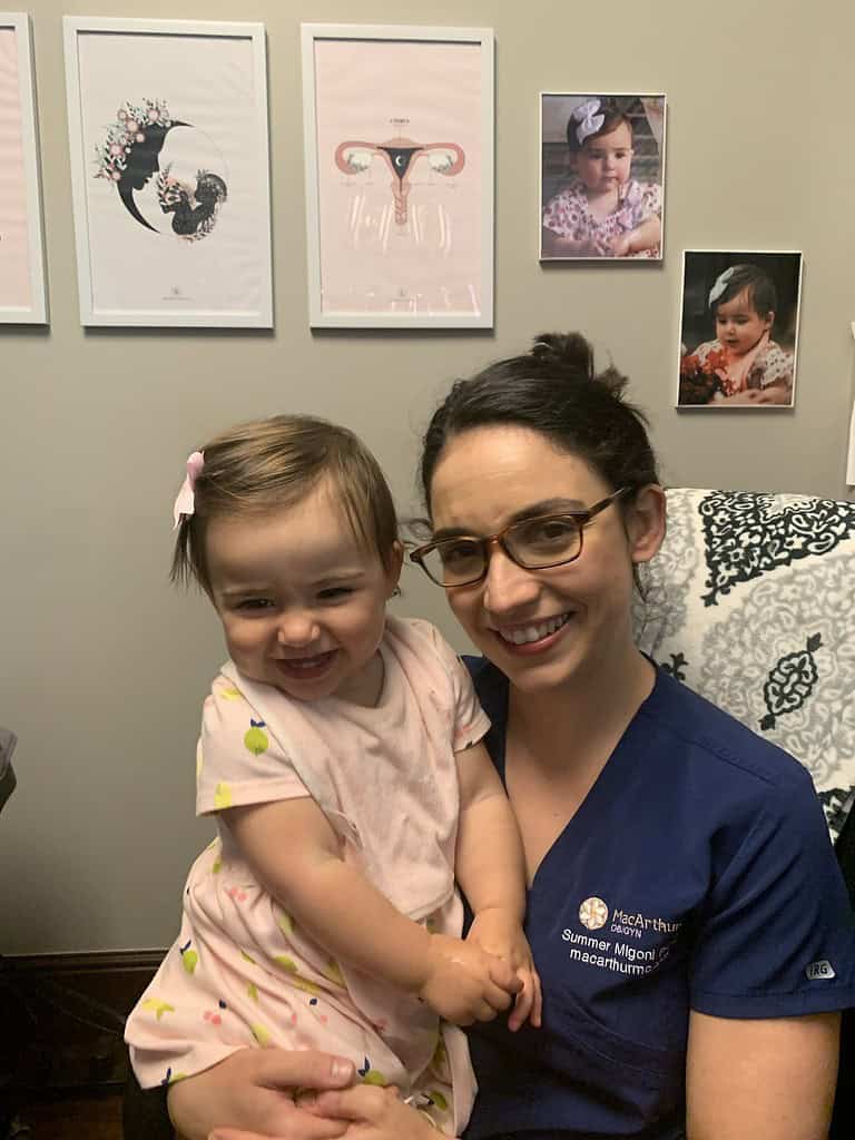 OBGYN PA with young girl in a medical office, infertility journey support.